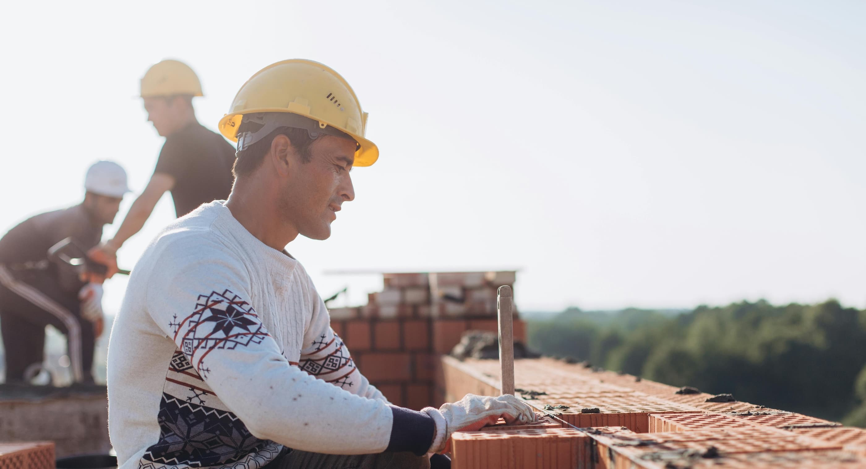 A construction worker laying bricks