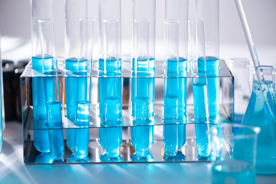 A series of test tubes filled with a blue liquid