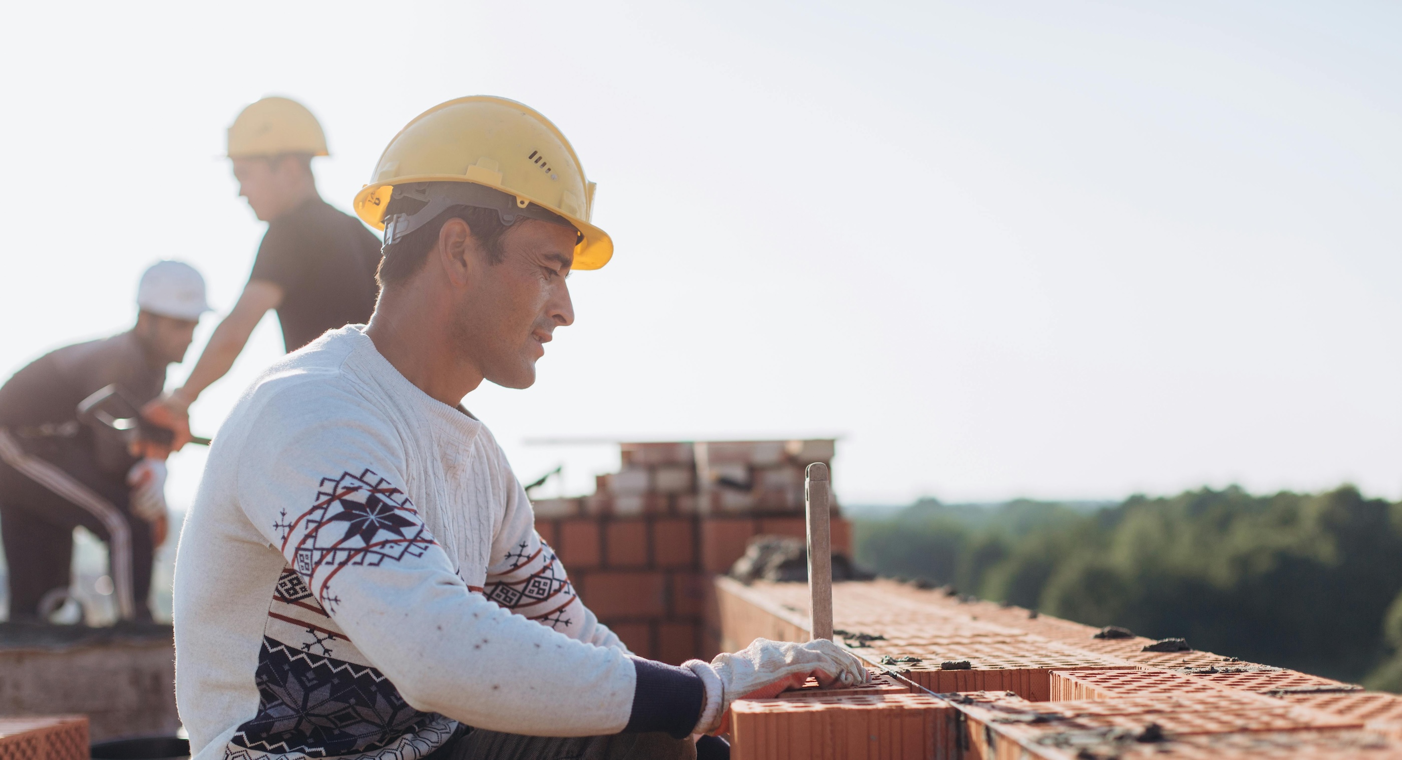 A construction worker laying bricks